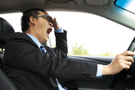 man yawning behind the wheel: Lorenzo Auto & Motorcycle Accident Blog