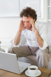 Distressed man on laptop: Lorenzo & Lorenzo Personal Injury Blog