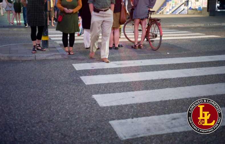 Group of pedestrians walking across crosswalk