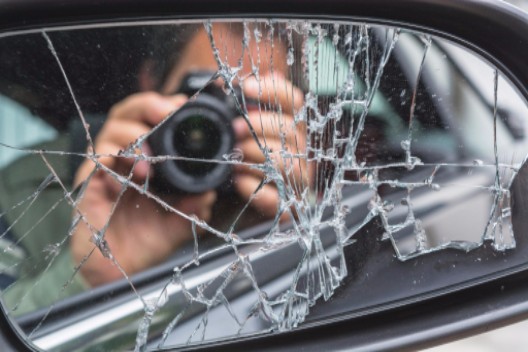 man taking pictures after accident